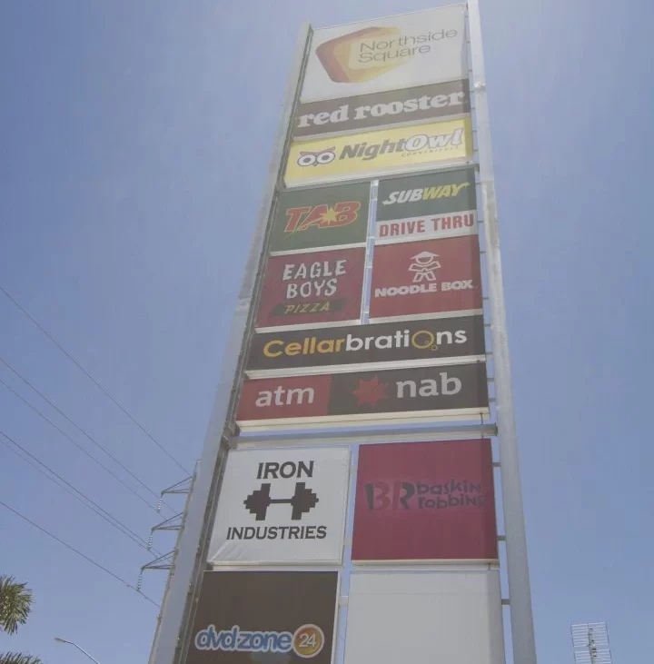 Vertical sign with Red Rooster, Subway, Eagle Boys, and Cellarbrations logos